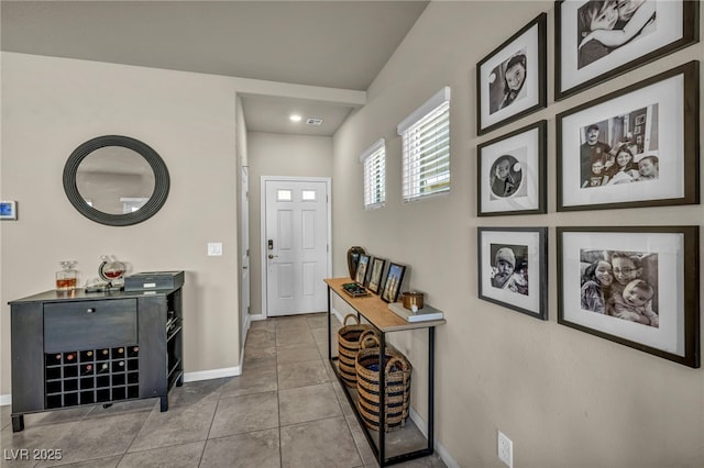 tiled entryway featuring baseboards