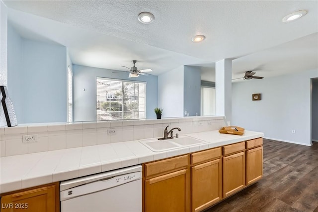 kitchen featuring dark wood finished floors, a sink, ceiling fan, and white dishwasher