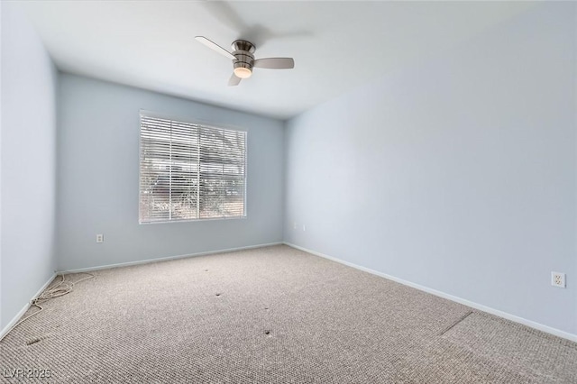 spare room featuring baseboards, a ceiling fan, and carpet