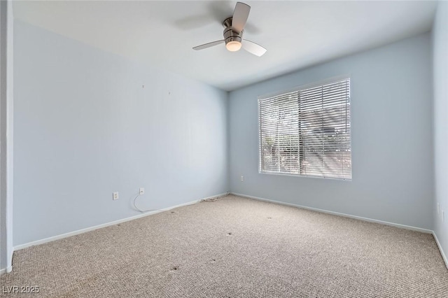 unfurnished room with baseboards, carpet floors, and a ceiling fan