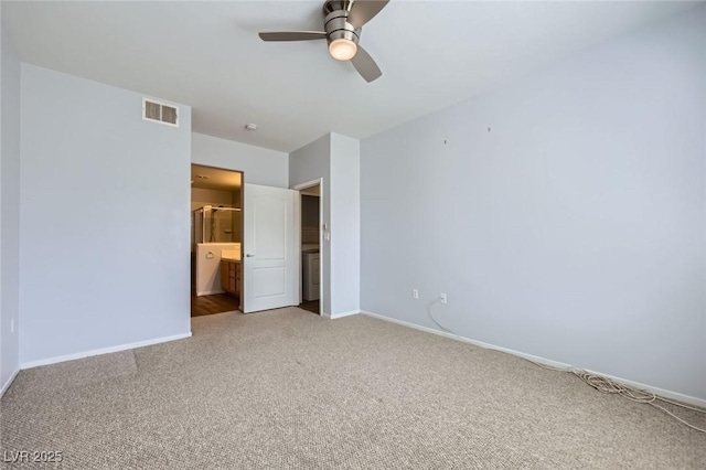 unfurnished bedroom with visible vents, baseboards, light carpet, ensuite bathroom, and a ceiling fan