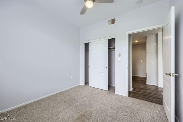 unfurnished bedroom featuring visible vents, carpet floors, baseboards, and a closet