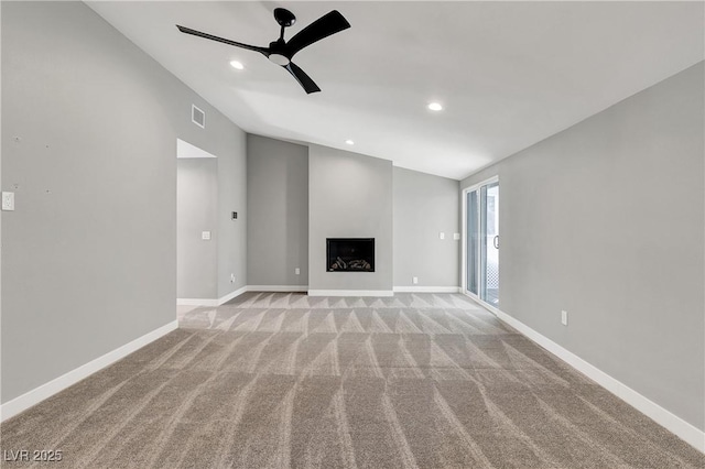 unfurnished living room with visible vents, light colored carpet, a ceiling fan, and vaulted ceiling