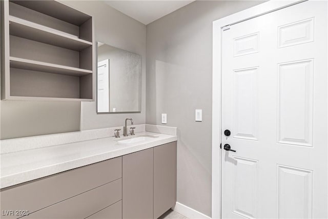 bathroom with vanity and baseboards