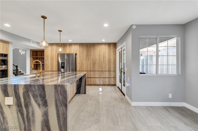 kitchen featuring light stone counters, visible vents, recessed lighting, a sink, and appliances with stainless steel finishes