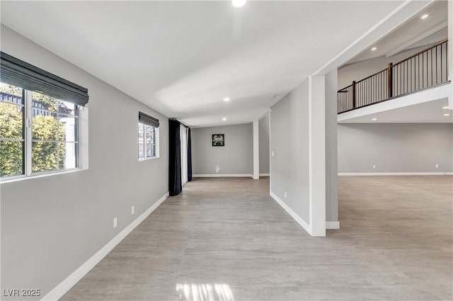 corridor featuring light wood-style floors, recessed lighting, and baseboards