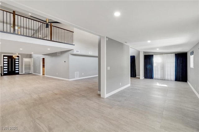 unfurnished living room featuring recessed lighting, baseboards, and visible vents