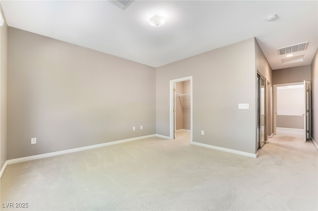 unfurnished bedroom with visible vents, light colored carpet, and baseboards