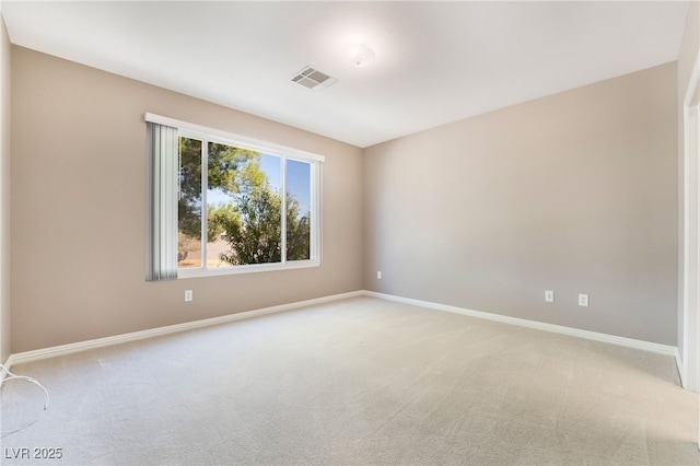 unfurnished room featuring visible vents, light colored carpet, and baseboards