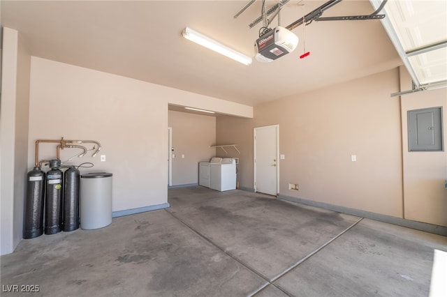 garage featuring electric panel, a garage door opener, baseboards, and washing machine and clothes dryer