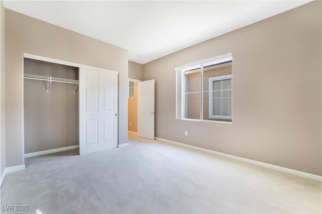 unfurnished bedroom featuring a closet, baseboards, and carpet floors