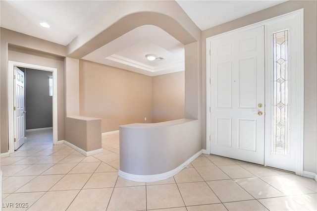 foyer with baseboards and light tile patterned flooring