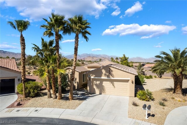 4963 Pensier St, Las Vegas, NV 89135 - view of front of home with concrete driveway, stucco siding, a mountain view, and an attached garage