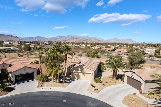 drone / aerial view featuring a residential view and a mountain view