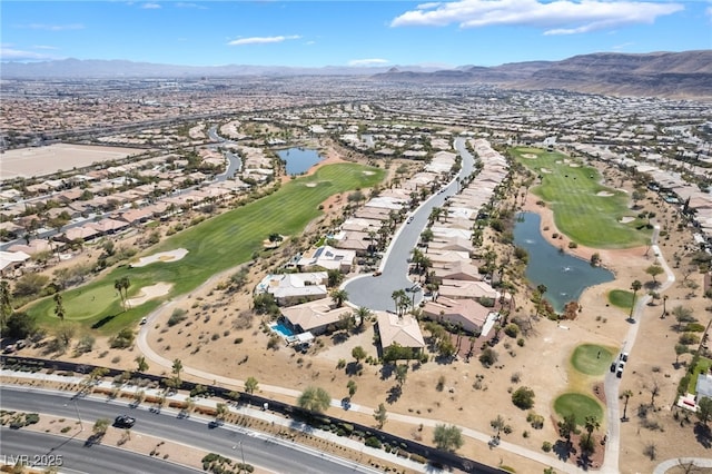 drone / aerial view with view of golf course, a residential view, and a water and mountain view