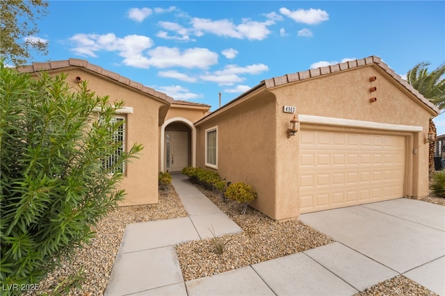 4963 Pensier St, Las Vegas, NV 89135 - mediterranean / spanish-style house featuring stucco siding, driveway, and a garage