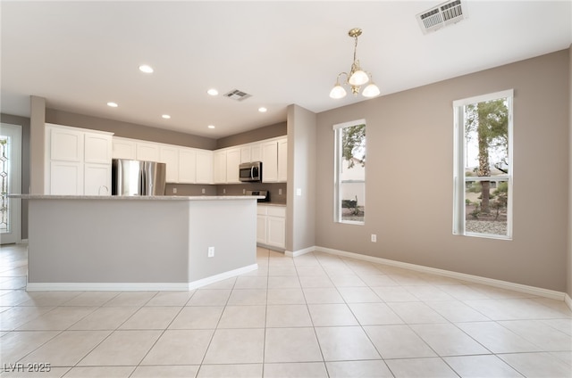 4963 Pensier St, Las Vegas, NV 89135 - kitchen with a chandelier, stainless steel appliances, light countertops, and visible vents