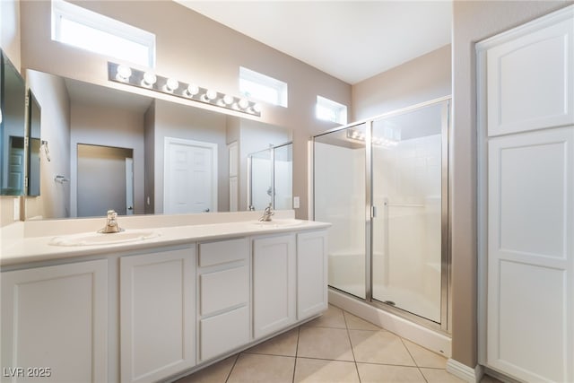 4963 Pensier St, Las Vegas, NV 89135 - bathroom featuring a stall shower, tile patterned flooring, double vanity, and a sink
