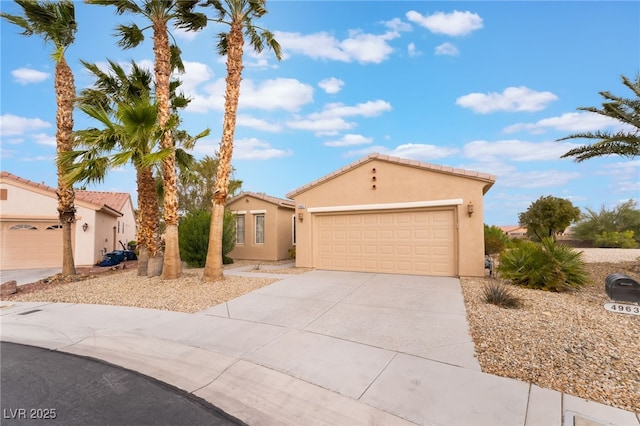 4963 Pensier St, Las Vegas, NV 89135 - view of front of house featuring concrete driveway, a tiled roof, stucco siding, and a garage