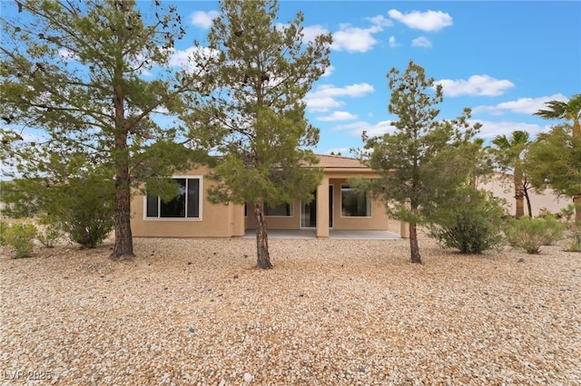 4963 Pensier St, Las Vegas, NV 89135 - view of front of home with stucco siding and a patio area