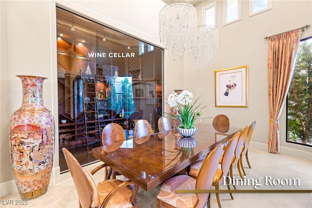 dining space with a notable chandelier and baseboards