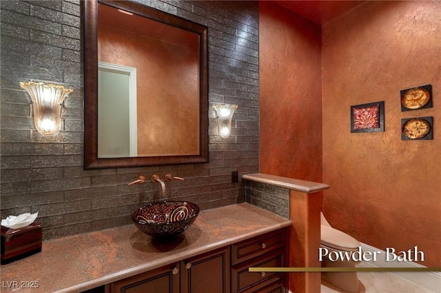 half bath featuring decorative backsplash, toilet, and vanity