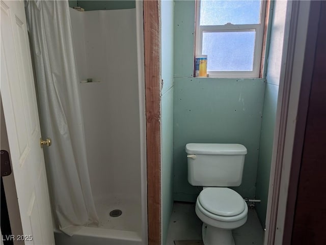 full bathroom with toilet and a stall shower