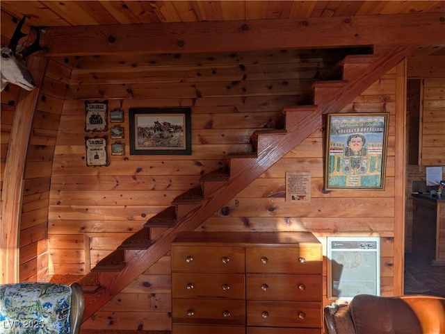 staircase featuring wooden ceiling and wood walls