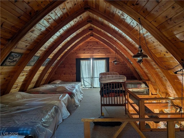 unfurnished bedroom with carpet, lofted ceiling, wood ceiling, and wood walls