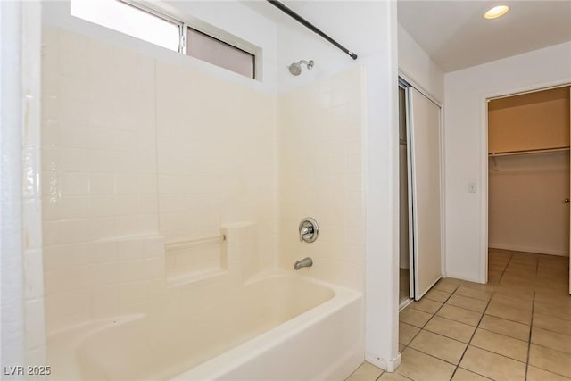 bathroom with tile patterned floors, shower / washtub combination, and a spacious closet