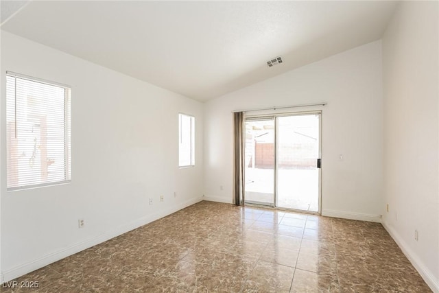 unfurnished room with visible vents, baseboards, and vaulted ceiling