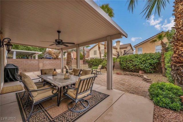 view of patio / terrace featuring area for grilling, outdoor dining area, a ceiling fan, and a fenced backyard