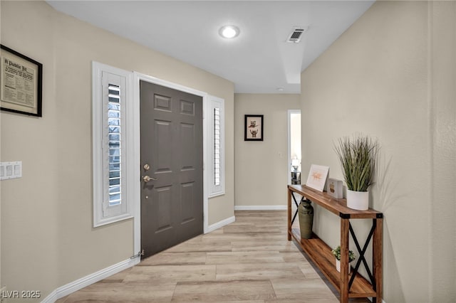 entrance foyer featuring light wood-type flooring, visible vents, and baseboards