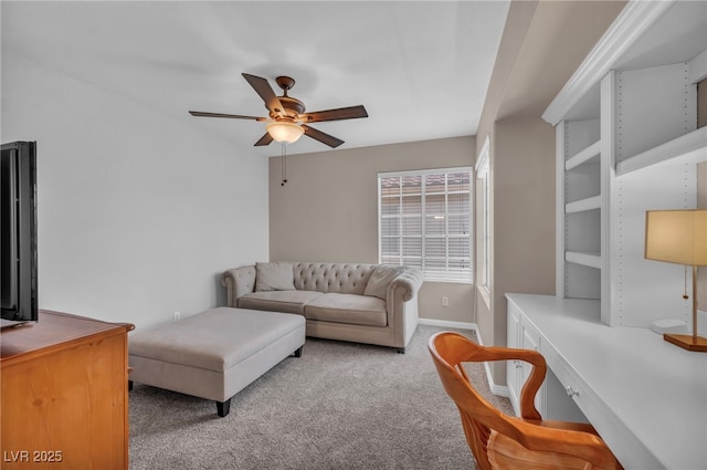 carpeted living room with baseboards and a ceiling fan