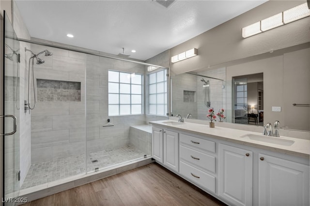 full bath featuring a sink and a shower stall