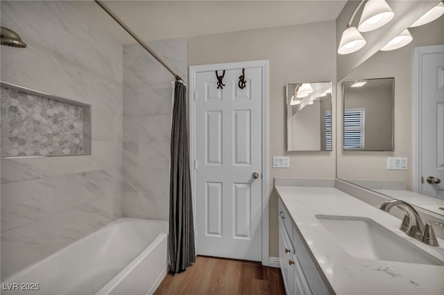 bathroom with shower / bath combo with shower curtain, wood finished floors, and vanity