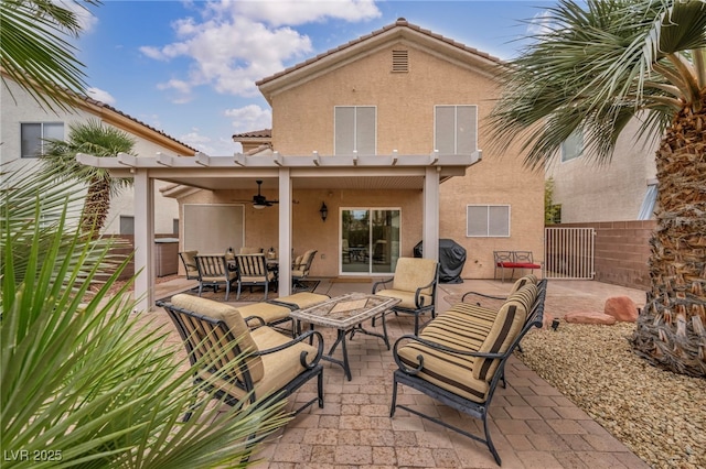 back of house featuring stucco siding, a tile roof, fence, ceiling fan, and a patio area