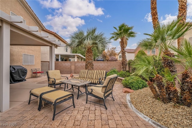 view of patio with an outdoor hangout area, fence, and a grill