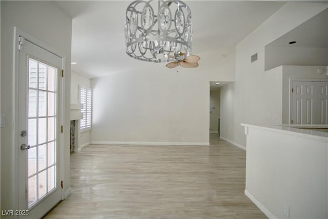 unfurnished dining area featuring visible vents, light wood-style flooring, and baseboards