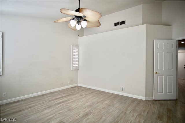 unfurnished room featuring visible vents, baseboards, wood finished floors, and a ceiling fan