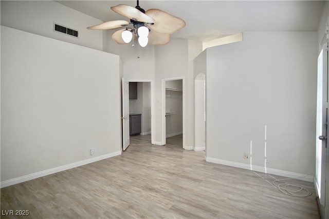 unfurnished bedroom featuring light wood finished floors, visible vents, a ceiling fan, and baseboards