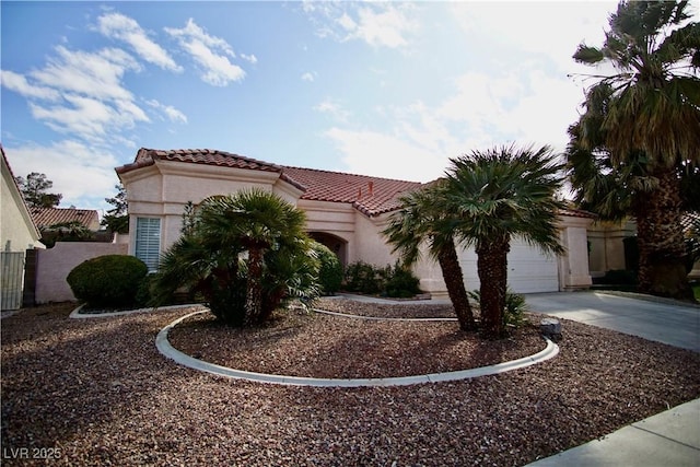 mediterranean / spanish house with a garage, stucco siding, driveway, and a tiled roof