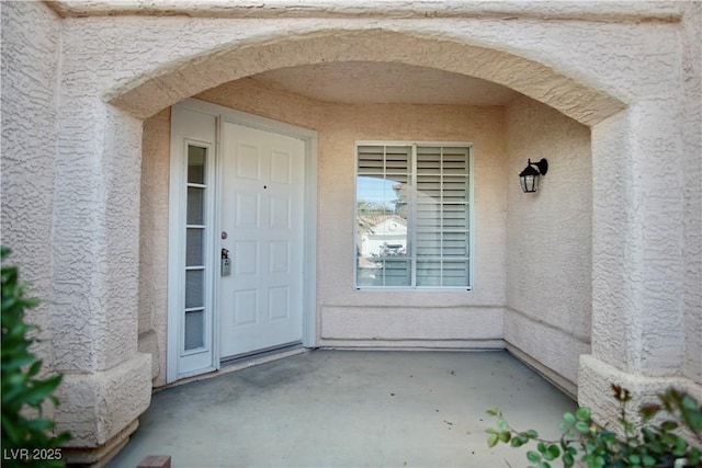 doorway to property with stucco siding and a patio