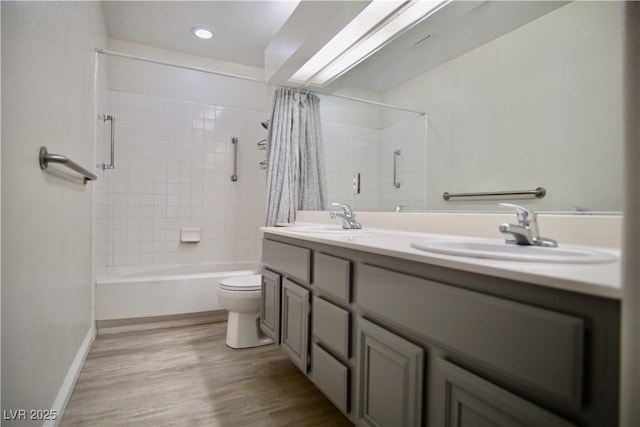 full bathroom featuring a sink, toilet, wood finished floors, and shower / bath combination with curtain