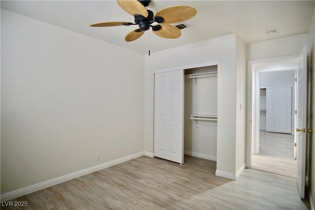 unfurnished bedroom with visible vents, ceiling fan, baseboards, wood finished floors, and a closet