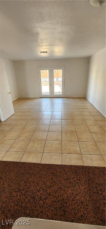 510 Holick Ave, Henderson, NV 89011 - spare room with light tile patterned flooring and a textured ceiling