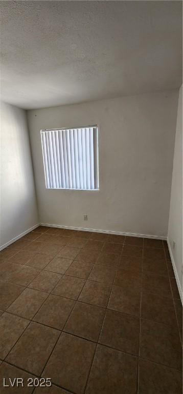 510 Holick Ave, Henderson, NV 89011 - spare room featuring tile patterned floors and baseboards