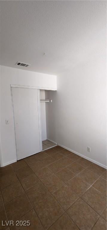 510 Holick Ave, Henderson, NV 89011 - unfurnished room featuring dark tile patterned floors and baseboards