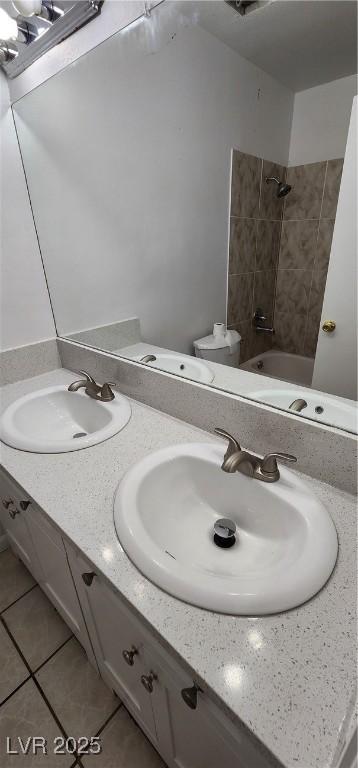 510 Holick Ave, Henderson, NV 89011 - full bathroom with double vanity, tile patterned floors, and shower / tub combination