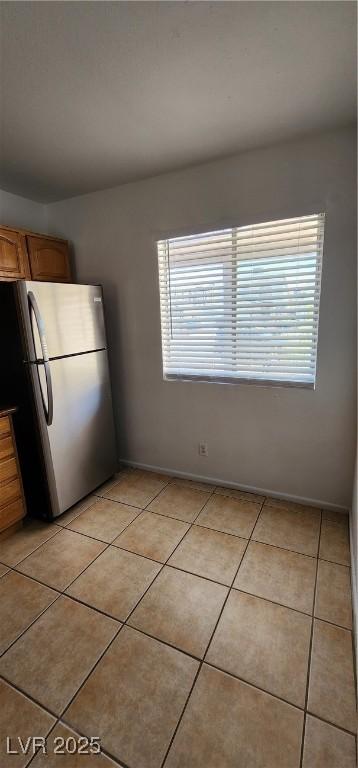 510 Holick Ave, Henderson, NV 89011 - kitchen featuring freestanding refrigerator, plenty of natural light, and light tile patterned floors